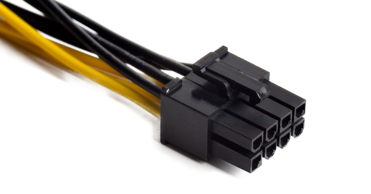 A small black, rectangular connector with eight pins that connect to four black and four yellow electric wires.