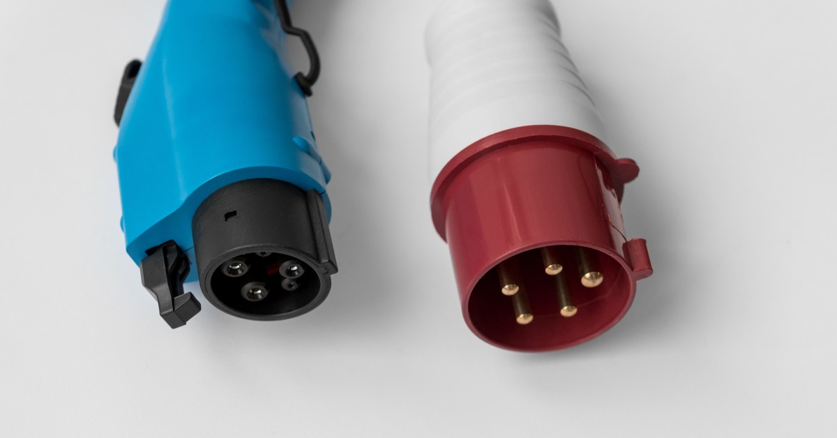 Two five-pin electrical connectors on a white surface. One connector is blue-and-black, the other is red-and-white.