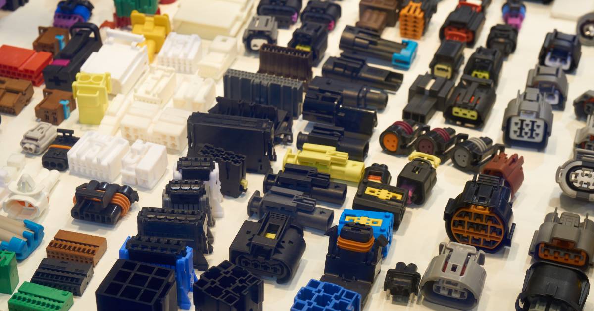A large collection of pin connectors in a range of shapes, colors, and sizes all suited for different automotive needs.